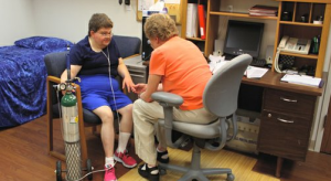 Shelley Schultz, left, a residential client of Cottonwood, Inc. in Lawrence, talks with registered nurse Pat Turmes, who works at Cottonwood's clinic.-Photo by Mike Shields