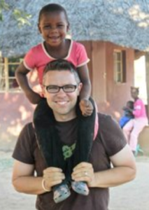 Kearny County Hospital CEO Benjamin Anderson has been to Zomba, Zimbabwe five times in the past four years doing medical mission work. He is pictured here with one of the children from the village.- Photo by Tim Walter