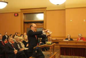 Photo by Andy Marso Tuck Duncan, a lobbyist for the wine and spirits industry, used a water bottle and a bowl of jelly beans to illustrate how much those industries are taxed. Duncan joined with tobacco industry representatives Tuesday to oppose tax increases.