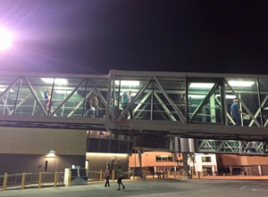 Passengers boarding (and waving!) for the first departure out of our new terminal!- courtesy photo