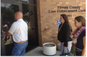 Shona Banda (right) enters the Finney County Law Enforcement Center with her attorney, Sarah Swain (center). Photo by Bryan Thompson