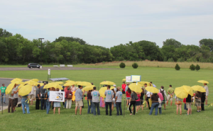 Participants in a rally Tuesday hold umbrellas to protest a proposal by Westar to make solar customers pay a higher monthly flat fee. ANDY MARSO HEARTLAND HEALTH MONITOR