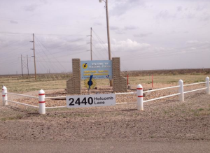 Photo by Bryan Thompson Sign at the entrance to the Holcomb Generating Station, where the proposed expansion remains a plot of bare dirt.