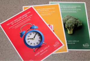 These posters, created by JNA Advertising, will be used in an ad campaign urging Kansas employers to report new hires for child support collection. CREDIT ANDY MARSO/KHI NEWS