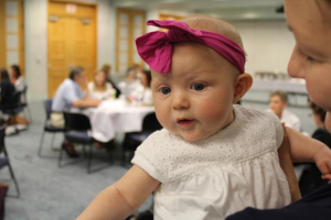 Photo by Dave Ranney Lucille Peschel, 4 months, was the youngest participant in a Kansas Action for Children-sponsored forum. Monday’s forum focused on upcoming reforms in the federal government’s support for child care assistance and early childhood development programs. She was accompanied by her mother, Patty Peschel, who runs the Kansas Child Care Training Opportunities program in Manhattan.