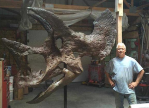 Neal Larson, a geologist, paleontologist and president of Larson Paleo Unlimited in Hill City, S.D., has removed ironstone and plaster of paris from a rare fossil dinosaur skull, a process he began in March 2013. photo courtesy Alan Dietrich