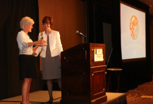Photo by Mike Sherry Kathleen Sebelius, left, former Kansas governor and U.S. secretary of health, receives a token of appreciation from Dr. Bridget McCandless, CEO of the Health Care Foundation of Greater Kansas City. Sebelius spoke Tuesday in Kansas City, Mo., at an event marking the foundation’s first decade