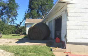 Tornado damage in Miami County KS. This hay bale was blown into the house photo National Weather Service
