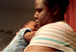 Erica Hardin holds her 3-month-old son, Marcus, at home. CREDIT TODD FEEBACK / HALE CENTER FOR JOURNALISM AT KCPT