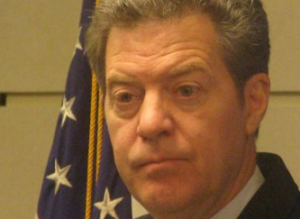 Photo by Dave Ranney Gov. Sam Brownback and other Kansas officials issued news releases outlining a lawsuit against the federal government. The suit claims a provision of the ACA that imposes a tax on health care plans is unlawful because it also applies to insurance companies that have contracts to administer Medicaid, known in Kansas as KanCare.