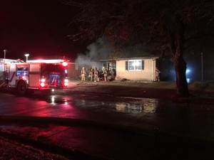 Firefighers work to extinguish a house fire in the 400 block of Rahm Sunday evening (Photo by Terry Tebrugge/Salina Post)