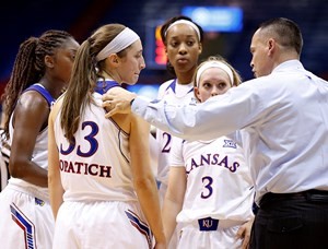 Head coach Brandon Schneider directs a huddle against Texas Southern.