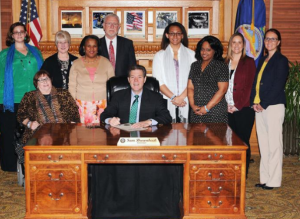 Photo by Kansas Department for Children and Families Michael Myers, fourth from left in back row, is retiring from his job overseeing the state’s foster care program. Some critics of the Kansas Department for Children and Families say he is among those responsible for what they believe has been a concerted effort to prevent same-sex couples in Kansas from adopting children. 