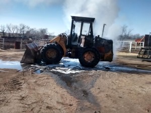 Fire damage to a loader and shed.