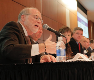 As Kansas lawmakers looked on, Tom Bell of the Kansas Hospital Association made a point Tuesday at a forum on Medicaid expansion held at Johnson County Community College. MIKE SHERRY / HEARTLAND HEALTH MONITOR