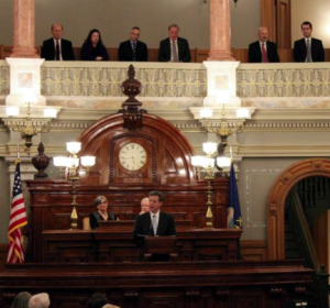 Photo by Susie Fagan/KHI News Service In his State of the State speech Tuesday night, Gov. Sam Brownback announced the creation of a task force to “address the problems of health care delivery in rural Kansas.” Seated behind Brownback are Senate President Susan Wagle, left, and Speaker of the House Ray Merrick. - 