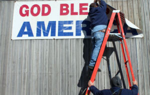 photo courtesy Joplin Globe Robert Troxel, U.S. Postal Service Maintenance Tech begins removal of the banner on Wednesday