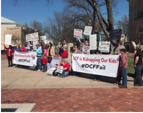 Protesters on Thursday afternoon outside the Riley Co. Courthouse