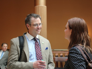 Photo by Andy Marso Tim Wood talks to Kari Ann Rinker, a lobbyist for the National Multiple Sclerosis Society, at the statehouse. Interhab announced Thursday that Wood will become the organization's executive director in September, replacing Tom Laing, seated at left.