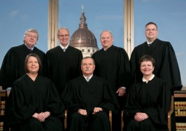 Kansas Supreme Court Seated left to right: Hon. Marla J. Luckert, Hon. Lawton R. Nuss, Chief Justice; Hon. Carol A. Beier. Standing left to right: Hon. Dan Biles, Hon. Eric S. Rosen, Hon. Lee A. Johnson, and Hon. Caleb Stegall.