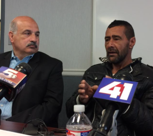 Syrian refugee Ahmad al-Abboud (right) tells his story through interpreter Fariz Turkmani at a press conference Monday morning in Kansas City. ALEX SMITH / KCUR 89-THREE