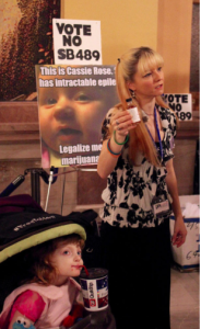 Christine Gordon says a version of a bill before the Kansas Legislature would only add fees and regulatory hurdles to cannabidiol, or CBD oil - a substance that already can be accessed legally at teh federal level. She displayed a bottle of the oil at a rally Wednesday at the Capitol. CREDIT ANDY MARSO / HEARTLAND HEALTH MONITOR