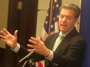 Gov. Sam Brownback announced more than $97 million in budget cuts Wednesday, including $56 million from the state's privatized Medicaid program known as KanCare. FILE PHOTO / HEARTLAND HEALTH MONITOR
