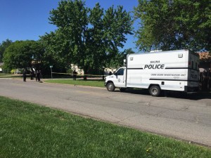Officers and investigators work at the crime scene on Thursday