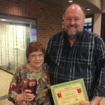 Tom Wilbur, President of Bank VI presents Linda Campbell with The Hero of the Week Award.