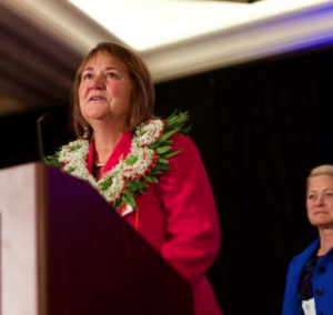 The Rev. Karen Oliveto accepts her election by the Western Jurisdiction as a United Methodist bishop. Oliveto is currently the senior pastor at Glide Memorial United Methodist Church in San Francisco, Calif. Her wife, the Rev. Robin Ridenour, stands behind her- photo United Methodist Church
