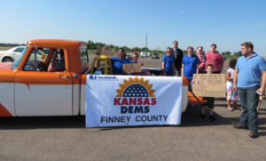 Photo by Lisa Rodriguez/KCUR The Finney County Democrats started meeting in December. With signs in English and Spanish at the Beef Empire Days Parade in Garden City, they were hoping to capture Latino voters’ attention.