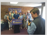 Photo by Peggy Lowe/KCUR Eric Pahls, press secretary for Roger Marshall, takes a photo of the members of a coalition of agriculture groups Marshall calls his “Farm Team.” The coalition endorsed Marshall over incumbent GOP U.S. Rep. Tim Huelskamp.
