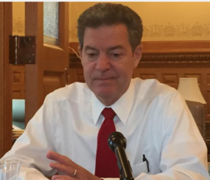 Photo by Jim McLean/KHI News Service In a rare, informal conversation with Statehouse reporters late last week, Brownback said the results of the recent primary election aren’t causing him to reconsider his positions on tax cuts, school finance or Medicaid expansion. ]