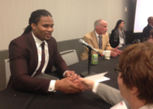 Josh Cribbs, left, an NFL kick returner and wide receiver, spoke as part of a panel discussion about head trauma earlier this year at a conference of the Association of Health Care Journalists. Cribbs talked about gaming the NFL’s concussion tests to stay on the field, even after he’d been hit so hard he blacked out temporarily. CREDIT ANDY MARSO / HEARTLAND HEALTH MONITOR