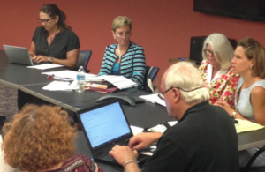 Photo by Andy Marso/KHI News Service Kelli Ludlum, right, assistant secretary for the Kansas Department for Aging and Disability Services, updated members of the Kansas Mental Health Coalition on the upcoming federal inspection at Osawatomie State Hospital. The coalition met Wednesday in Topeka. 