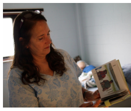 Judy Talbot leafs through a photo book with pictures of her daughter, Jill, during happier times at the beach or dressed up for Halloween. CREDIT ANDY MARSO / HEARTLAND HEALTH MONITOR