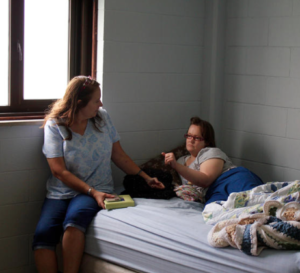 Judy Talbot, left, talks with her daughter, Jill, who is 32 and has autism and post-traumatic stress disorder. ANDY MARSO / HEARTLAND HEALTH MONITOR