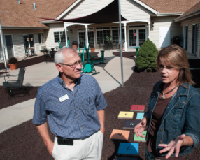 Ric Dalke, left, executive director of Compass Behavioral Health in Garden City, estimates that a cut in Medicaid reimbursements and the elimination of a 'health home' program have cut about $1 million from the center's $13 million budgets. He's shown here with Melanie Hamann of Compass Health Connection in Garden City.-CREDIT BRAD NADING