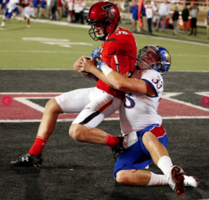 Jayhawks Keith Lineker tackles the Tech punter for a first half safety -photo University of Kansas Athletics