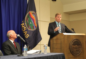 Photo by Andy Marso/KHI News Service Shawn Sullivan, right, the governor’s budget director, says this year’s Kansas revenue projections would have been more accurate if the process incorporated recommendations released Tuesday. At left is Sam Williams, a retired accountant selected to lead the working group that made the recommendations.