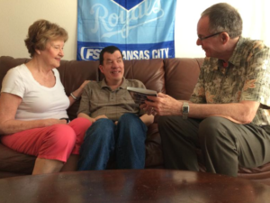 Nick Fugate (center) and his parents, Julie and Ron, have been adjusting to life on Kansas’ Medicaid waiting list for the developmentally disabled. ALEX SMITH / HEARTLAND HEALTH MONITOR