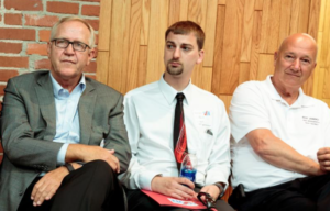 Photo by Amy Jeffries/KCUR Rep. Russ Jennings, right, sits with Kansas Senate 39 candidates Republican John Doll, left, and Democrat Zach Worf, center, at a candidate forum in Garden City ahead of the August primary. Jennings was unopposed both for the primary and the general election and is seeking the job of House speaker in the Kansas Legislature.