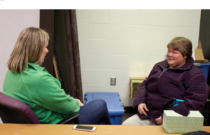 Kim Turley, left, of the Topeka Rescue Mission talks with Ashlyn Harcrow, who is staying at the mission as she recovers from domestic violence and tries to improve her mental health amid post-traumatic stress disorder, depression and anxiety. ANDY MARSO / HEARTLAND HEALTH MONITOR