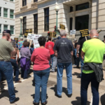 Police arrest 18 protesting in Kansas official’s office