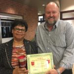 Tom Wilbur, President of Bank VI, presents Eleanor Jones with the Hero of the Week Award.