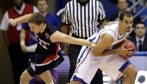 Belmont guard Reece Chamberlain, left, tries to steal the ball from Kansas forward Perry Ellis (34) during the first half Saturday in Lawrence. (AP Photo/Charlie Riedel)