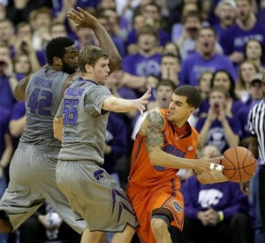 Florida guard Scottie Wilbekin, right, looks for a teammate to pass to as he is pressured by Kansas State guard Will Spradling (55) and forward Thomas Gipson (42)during the first half Saturday at the Sprint Center in Kansas City, Mo. (AP Photo/Charlie Riedel)