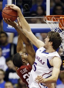 Kansas center Jeff Withey (5) blocks a shot by Oklahoma forward Cameron Clark (21) during the first half of an NCAA college basketball game in Lawrence, Kan., Saturday, Jan. 26, 2013. (AP Photo/Orlin Wagner)