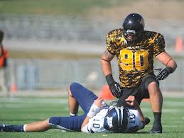 Ben Pister hovers over a Washburn Quarterback.