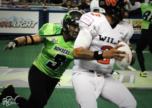 Pompey Festejo pressures Wild QB Rocky Hinds on March 16, 2013.